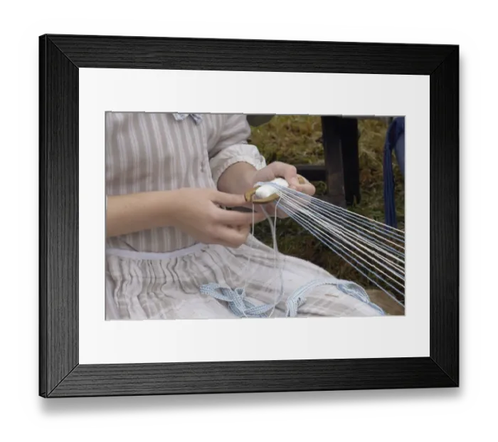 Framed Print : Reenactor weaving on a belt loom at a Revolutionary War reenactment
