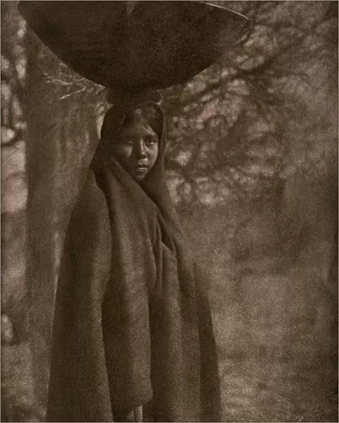 Maricopa woman carrying a basket on her head, 1907