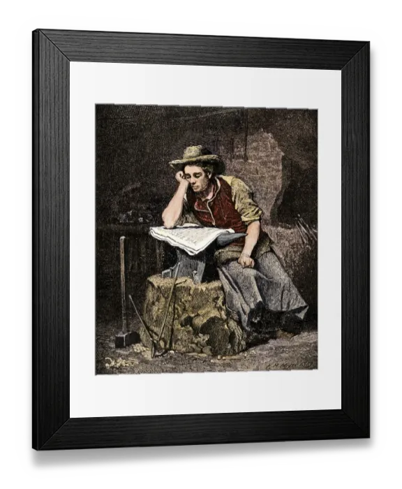 Framed Print : Young blacksmith reading a newspaper Framed Print : Young blacksmith reading a newspaper