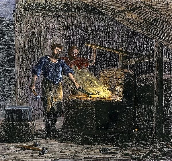 BUSN2A-00086. Blacksmith and his assistant at a forge.