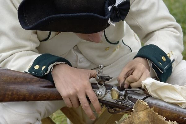 EVRV2D-00112. French soldier cleaning his musket at a reenactment on the