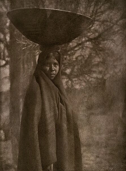Maricopa woman carrying a basket on her head, 1907