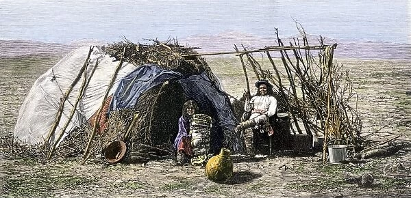 NATI2A-00078. Apache family in front of their wickiup, 1880s.