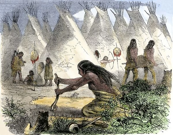 NATI2A-00092. Native American women curing buffalo hides in a tepee village.