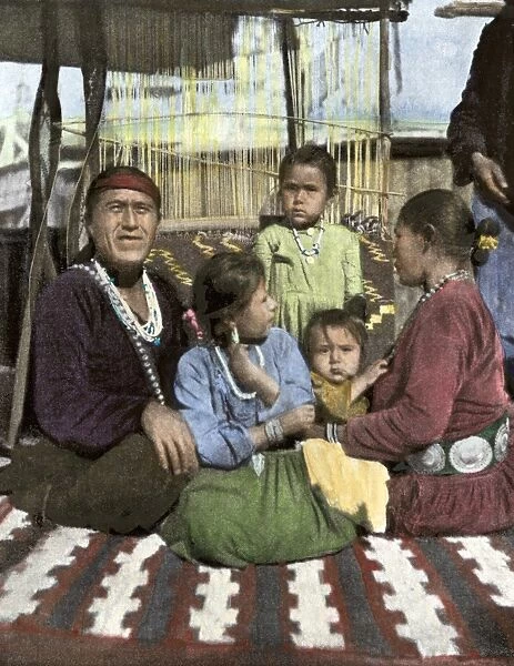 NATI2A-00175. Navajo family seated in front of their blanket loom, about 1900.