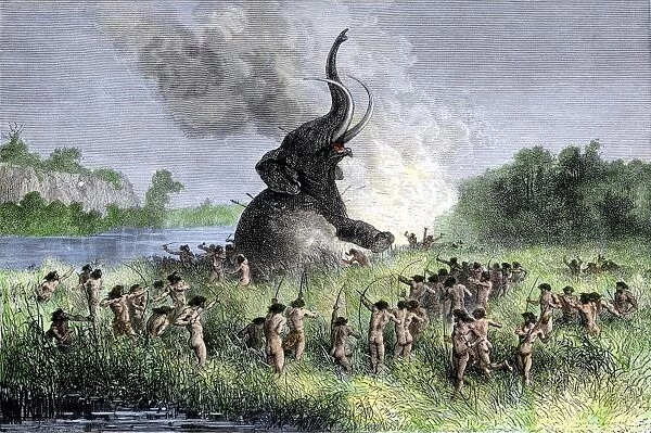 Prehistoric hunters surrounding a wooly mammoth