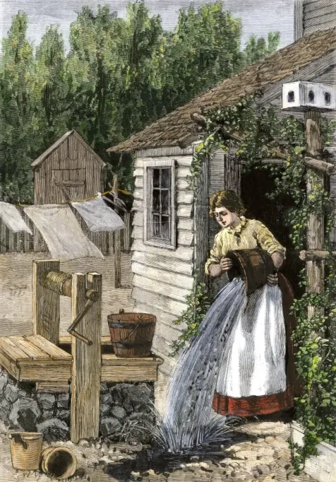 Framed Print : Woman in cottage doorway emptying a slop bucket near a well