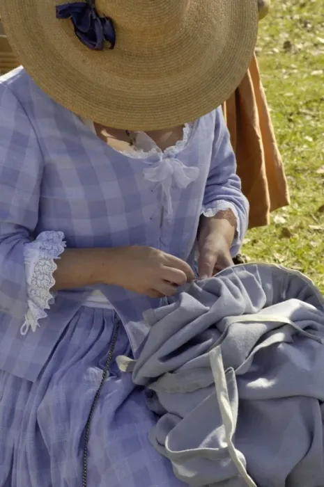 Framed Print : Woman reenactor sewing at Yorktown battlefield