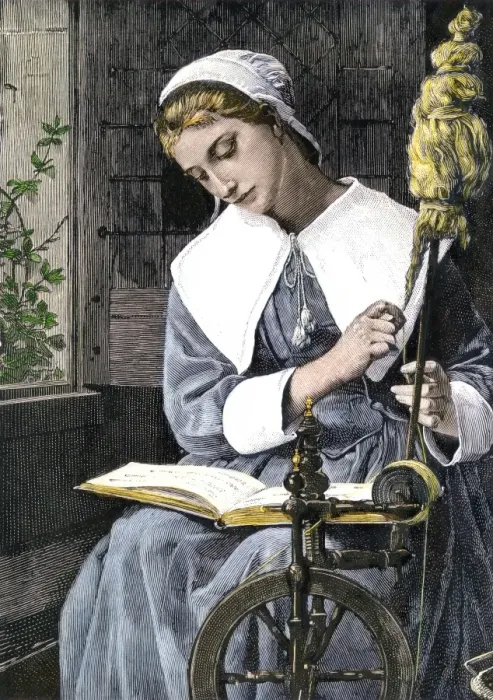 Framed Print : Young Puritan woman reading while spinning at her wheel