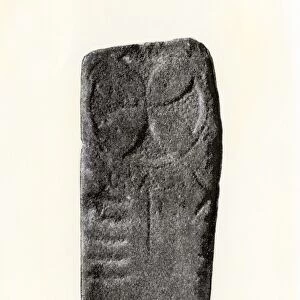 Ogham inscription and sun symbol on an Old Irish gravestone
