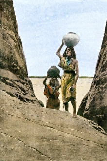 Ancestral Puebloan/Anasazi women carrying water in pots up to a mesa top