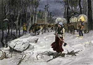 Rockies Prints: Covered wagon migrants in midwinter making camp for the night