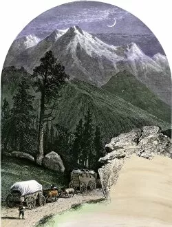 Oxen Collection: Covered wagons crossing the mountains