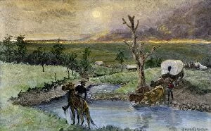 Dakota Territory Gallery: Covered wagons escaping a prairie fire