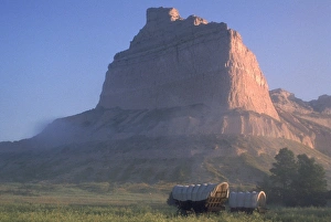 Nebraska Prints: Covered wagons on the Oregon Trail at sunrise