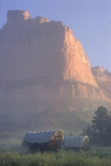 Nebraska Prints: Covered wagons on the Oregon Trail at sunrise