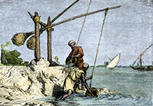 Egyptians drawing Nile water with a shadoof