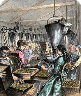 Factory workers making rifle cartridges