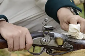 Battle Of Yorktown Prints: French soldier cleaning his musket at a reenactment on the Yorktown Battlefield