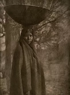 Arid Collection: Maricopa woman carrying a basket on her head, 1907