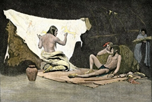 Native American shaman using pictures on a buffalo robe to cure a young mans
