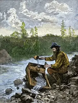 Rockies Prints: Prospector washing pebbles from a stream using a cradle device to sparate gold